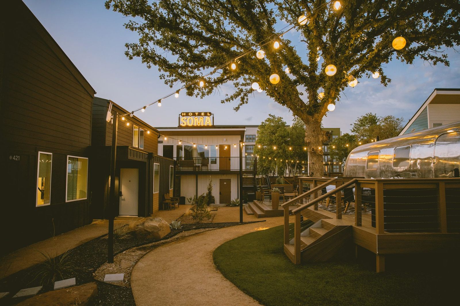 Golden-hour light across the Hotel SOMA courtyard and Airstream suites in South Main Village