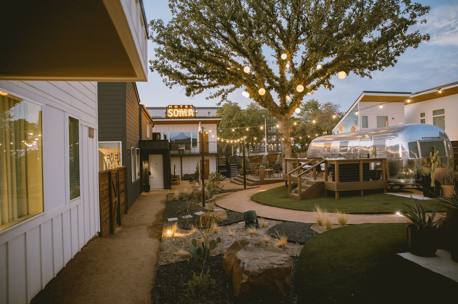 String-lit courtyard at twilight at Hotel SOMA in South Main Village, Fort Worth