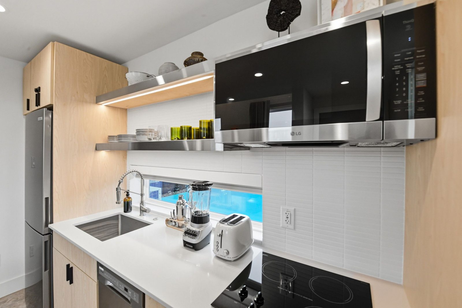 Casita kitchenette with stovetop and prep space at Hotel SOMA in Fort Worth