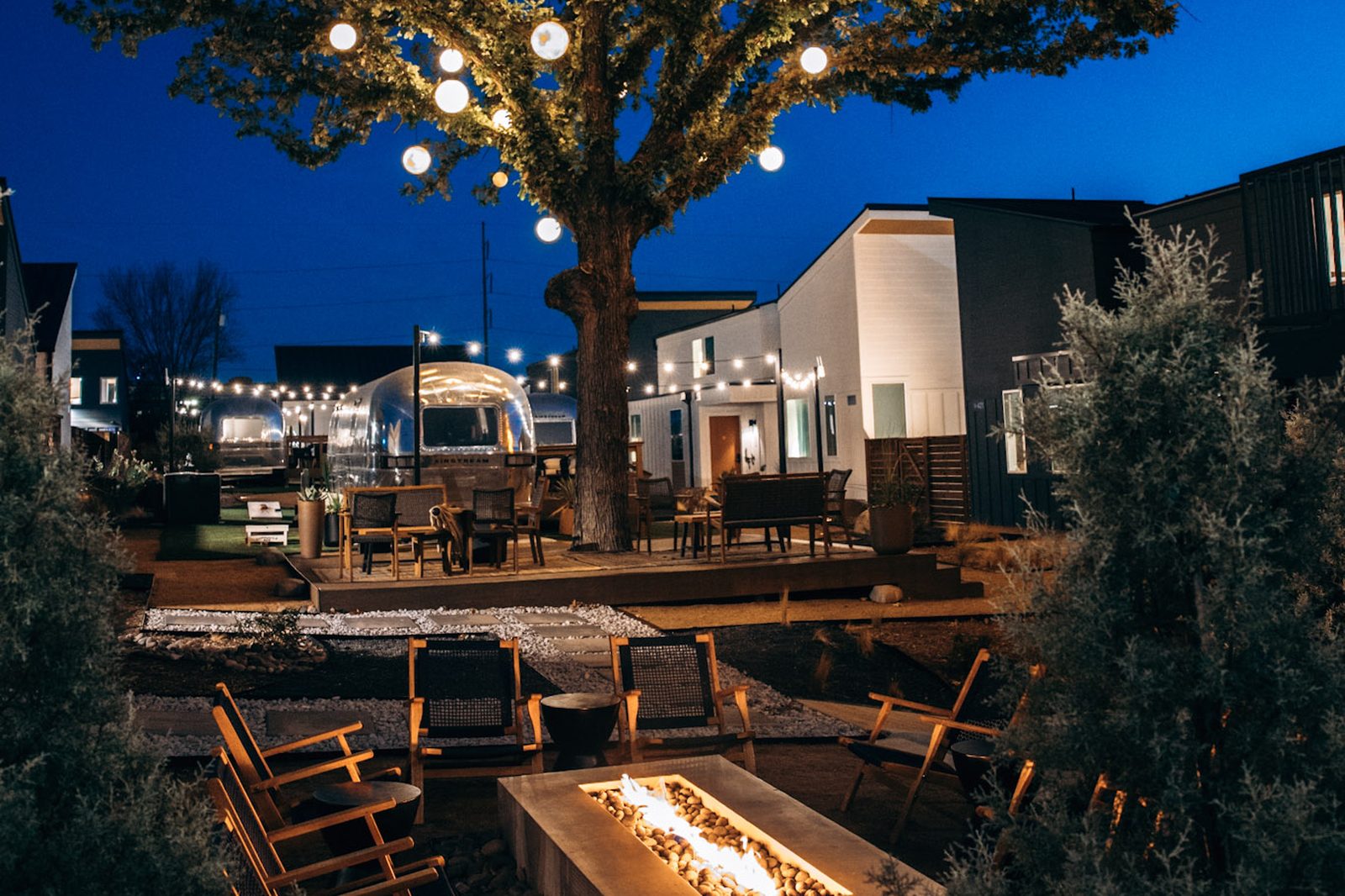 Hotel SOMA gated courtyard with fire pits and string lights in the evening