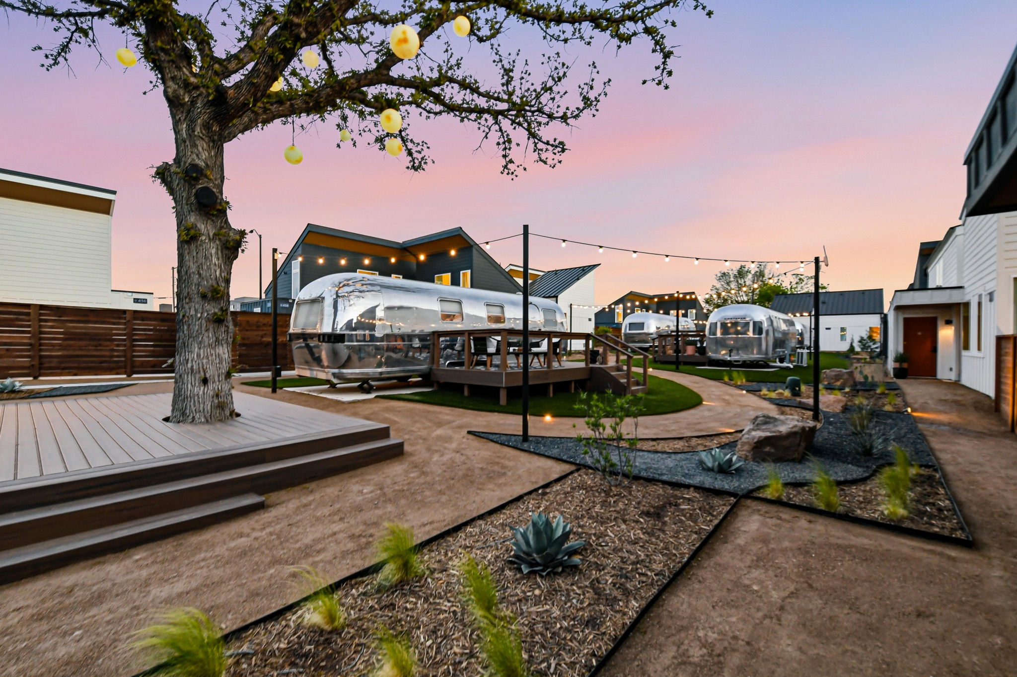 String-lit courtyard at twilight at Hotel SOMA in South Main Village, Fort Worth